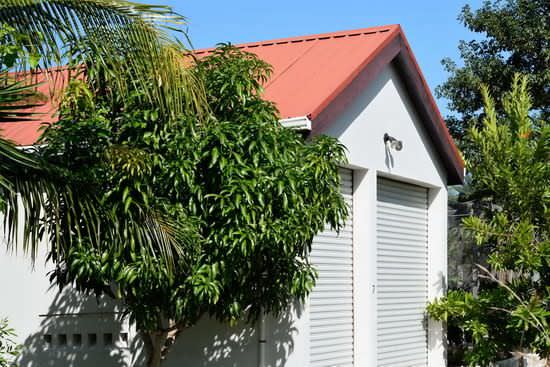 Two-door detached garage with red roof