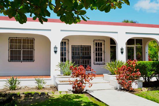 White house with arches and burgundy trim